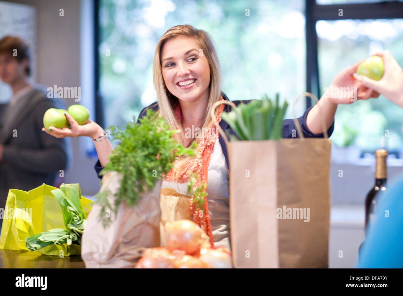 Young woman unpacking groceries Stock Photo