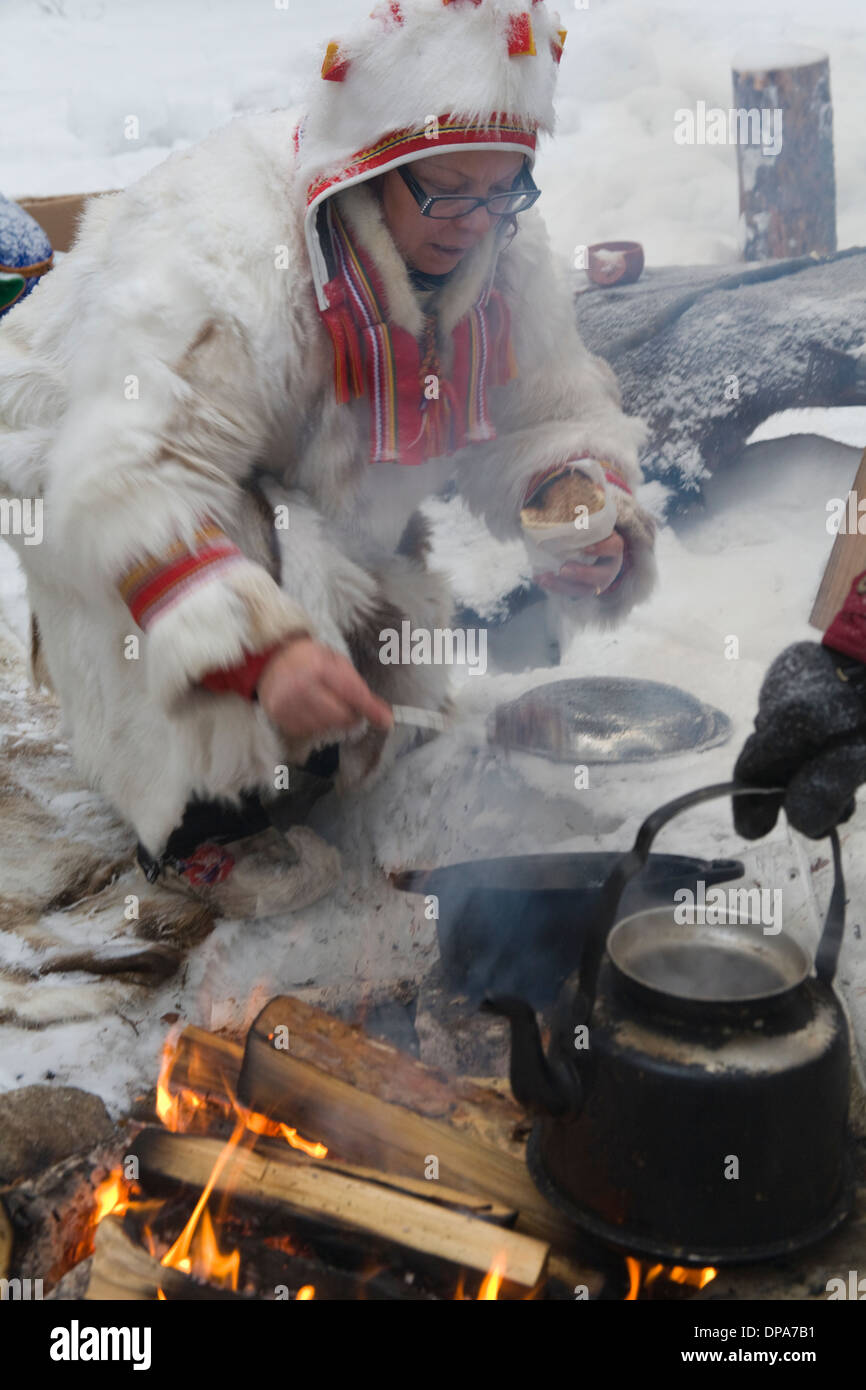 Outdoorlife Same Cooking on Campfire Coffee-cettle and frying Souvas Smoked Reindeer meat Jokkmokk Historic Fair Laponia Sweden Stock Photo