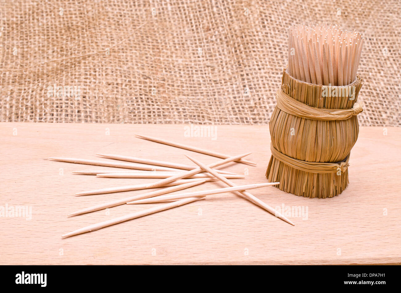 Wooden toothpicks in round wattled straw holder Stock Photo Alamy
