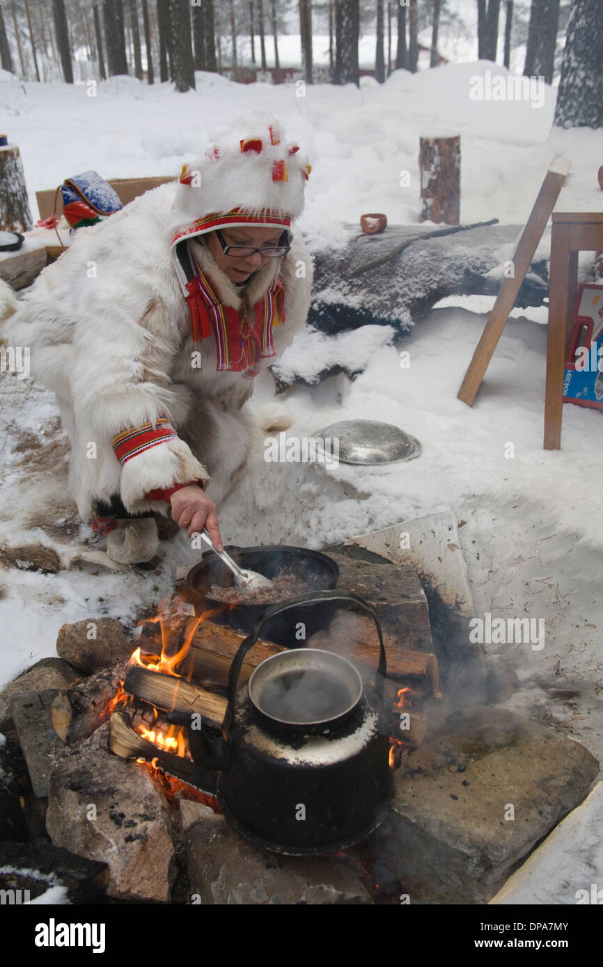 Outdoorlife Same Cooking on Campfire Coffee-cettle and frying Souvas Smoked Reindeer meat Jokkmokk Historic Fair Laponia Sweden Stock Photo