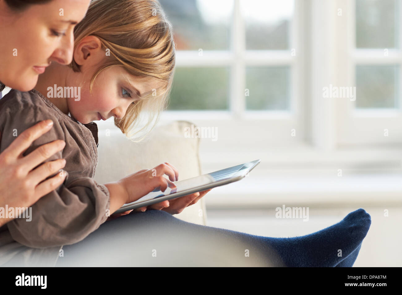Mother and daughter using digital tablet Stock Photo
