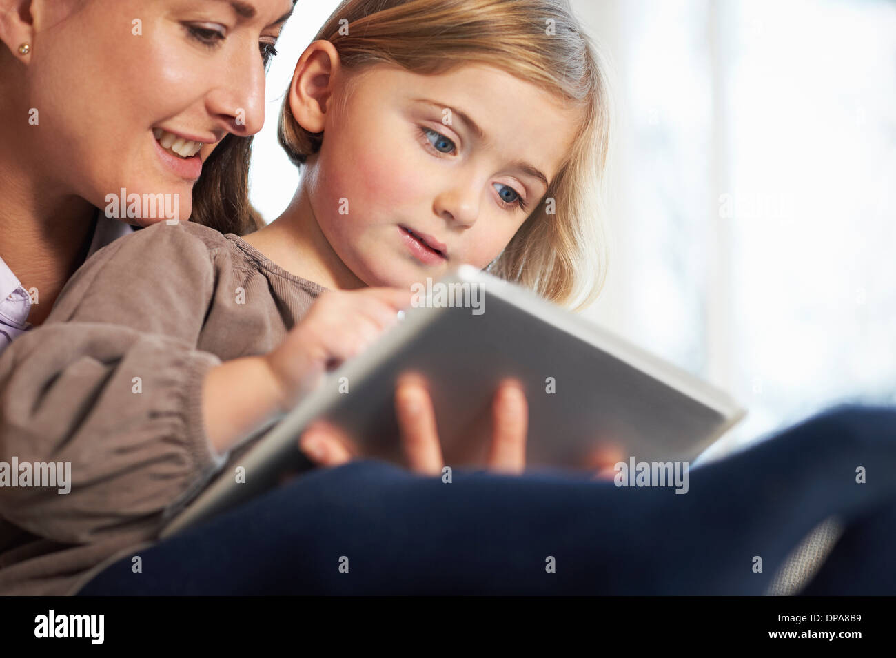Mother and daughter using digital tablet Stock Photo