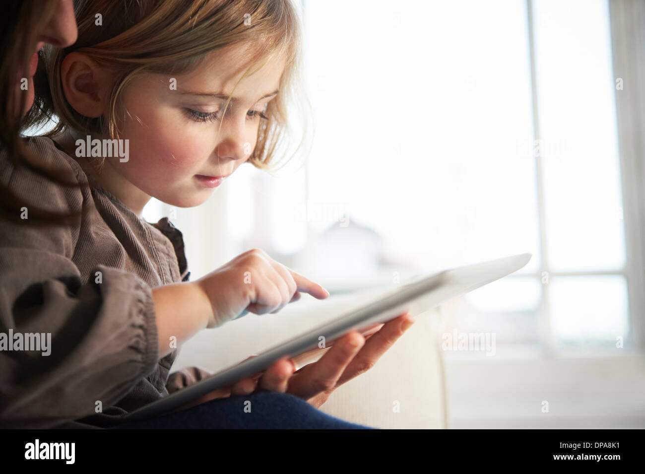 Mother and daughter using digital tablet Stock Photo