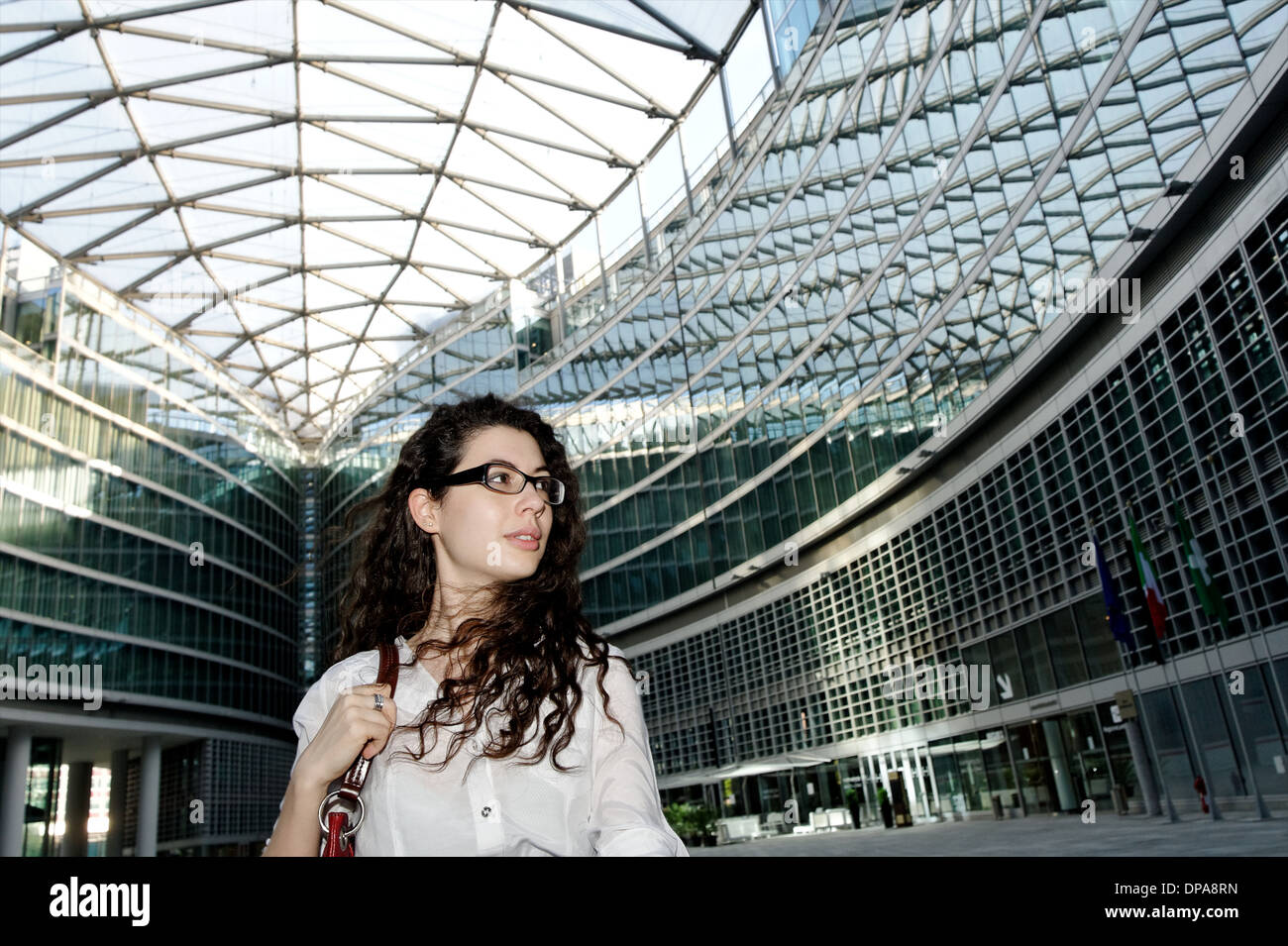 Young businesswoman in modern interior space Stock Photo