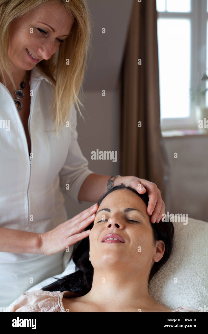 Beautician performing beauty treatment on woman Stock Photo