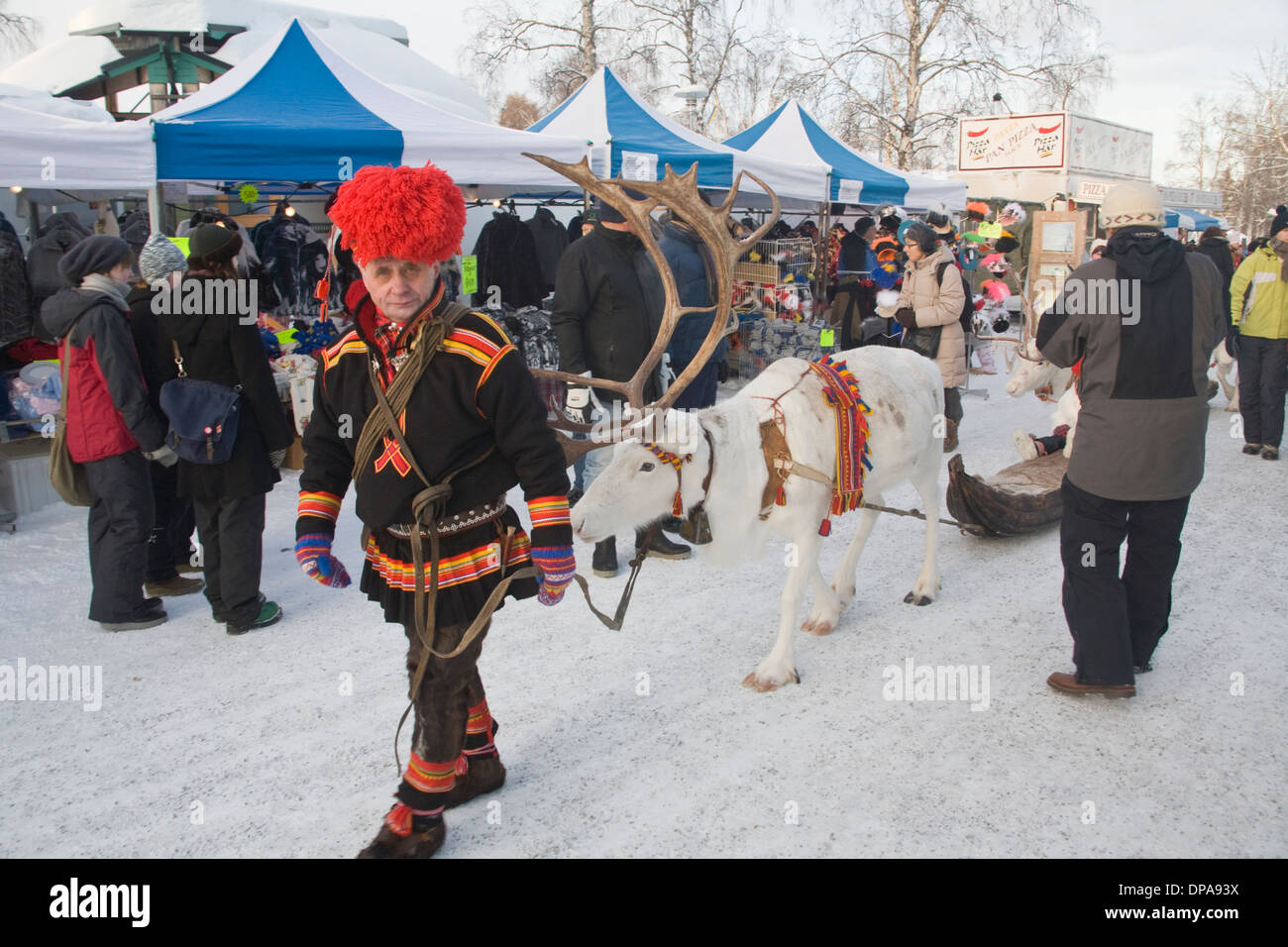 Traditional Reindeer caravan with Same Laplander in Folk costume Jokkmokk fair Laponia Sweden Winter Stock Photo