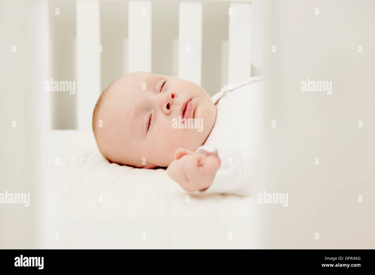 Baby in crib sleeping Stock Photo Alamy
