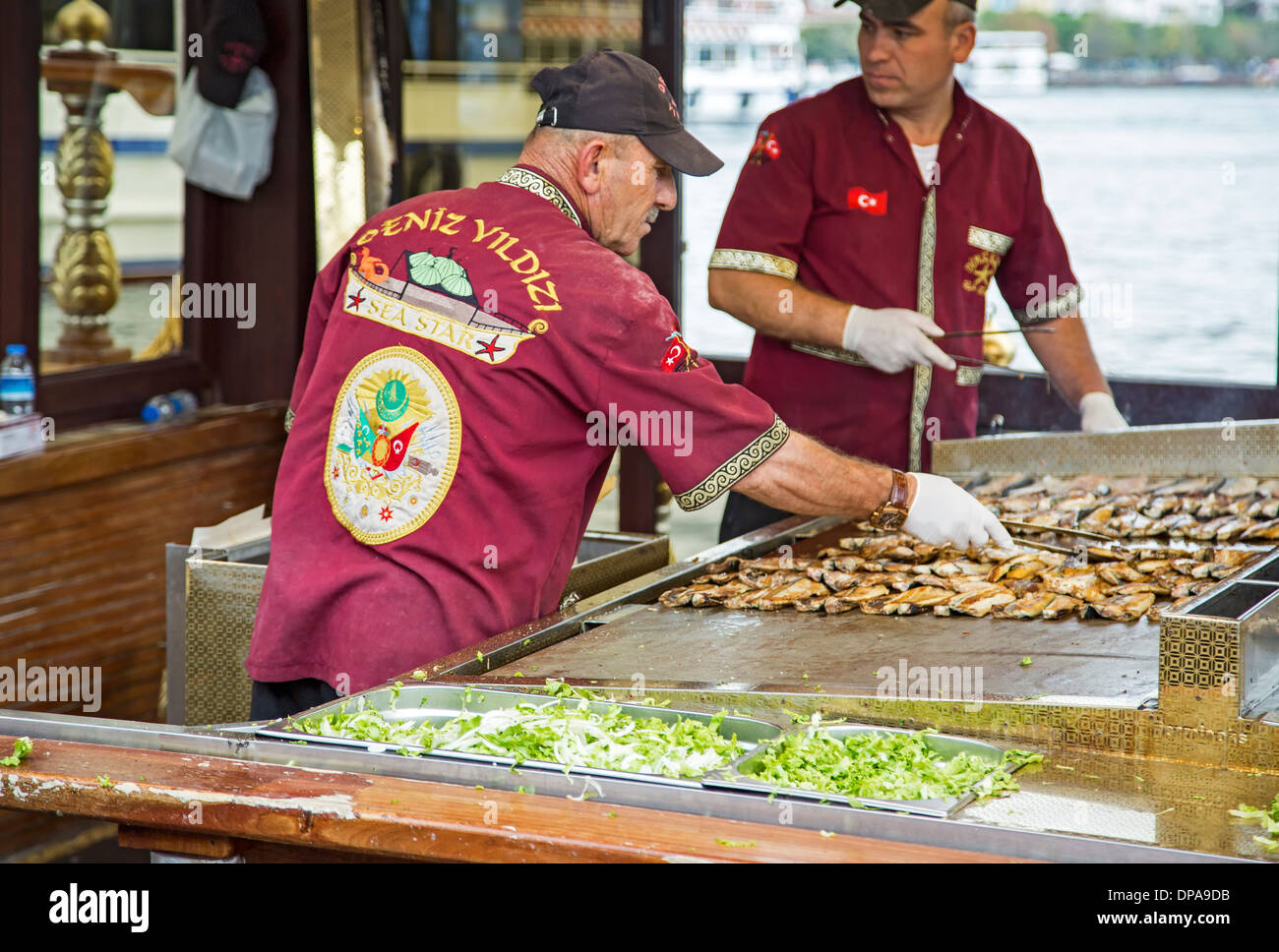 Cooks in fish sandwich restaurant boat, Eminonu, Istanbul, Turkey Stock Photo