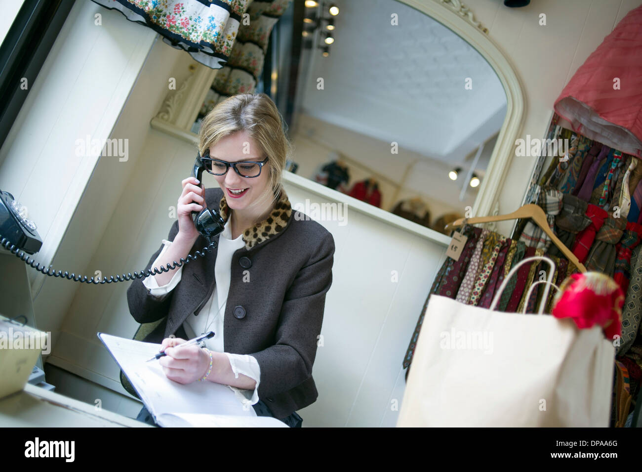 Sales assistant taking phone call Stock Photo