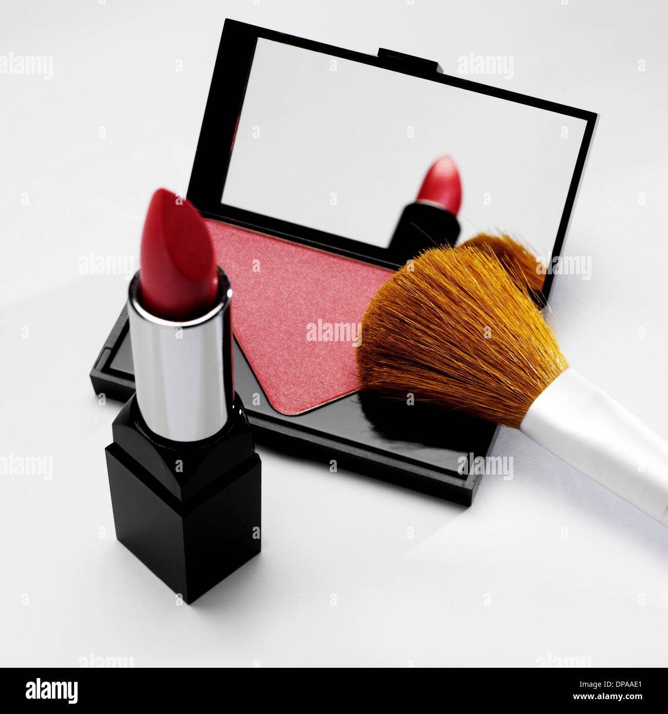 Rouge and lipstick with make up brush Stock Photo