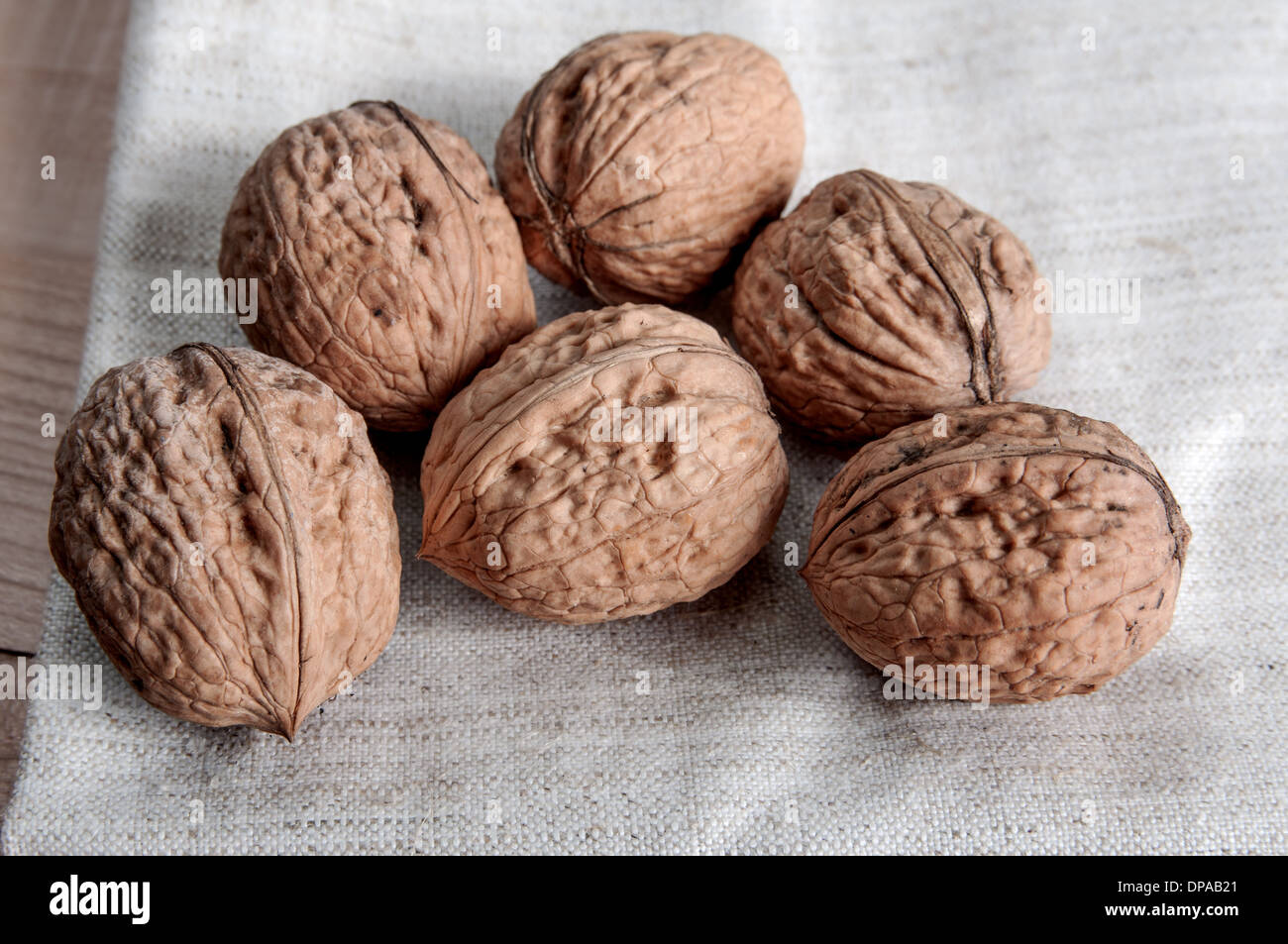 Close-up of a pile of nuts on wooden background Stock Photo