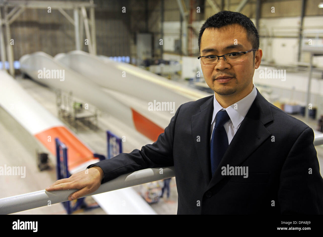 Lemwerder, Germany. 10th Jan, 2014. William Tang, commercial manager of rotor blade manufacturer for Onshore wind turbine facilities SGL-ROTEC, stands in the painting hall in Lemwerder, Germany, 10 January 2014. The company has been taken over by the German-Chinese family run business Betterlife and will operate under the name of CARBON-Rotec. Photo: INGO WAGNER/dpa/Alamy Live News Stock Photo