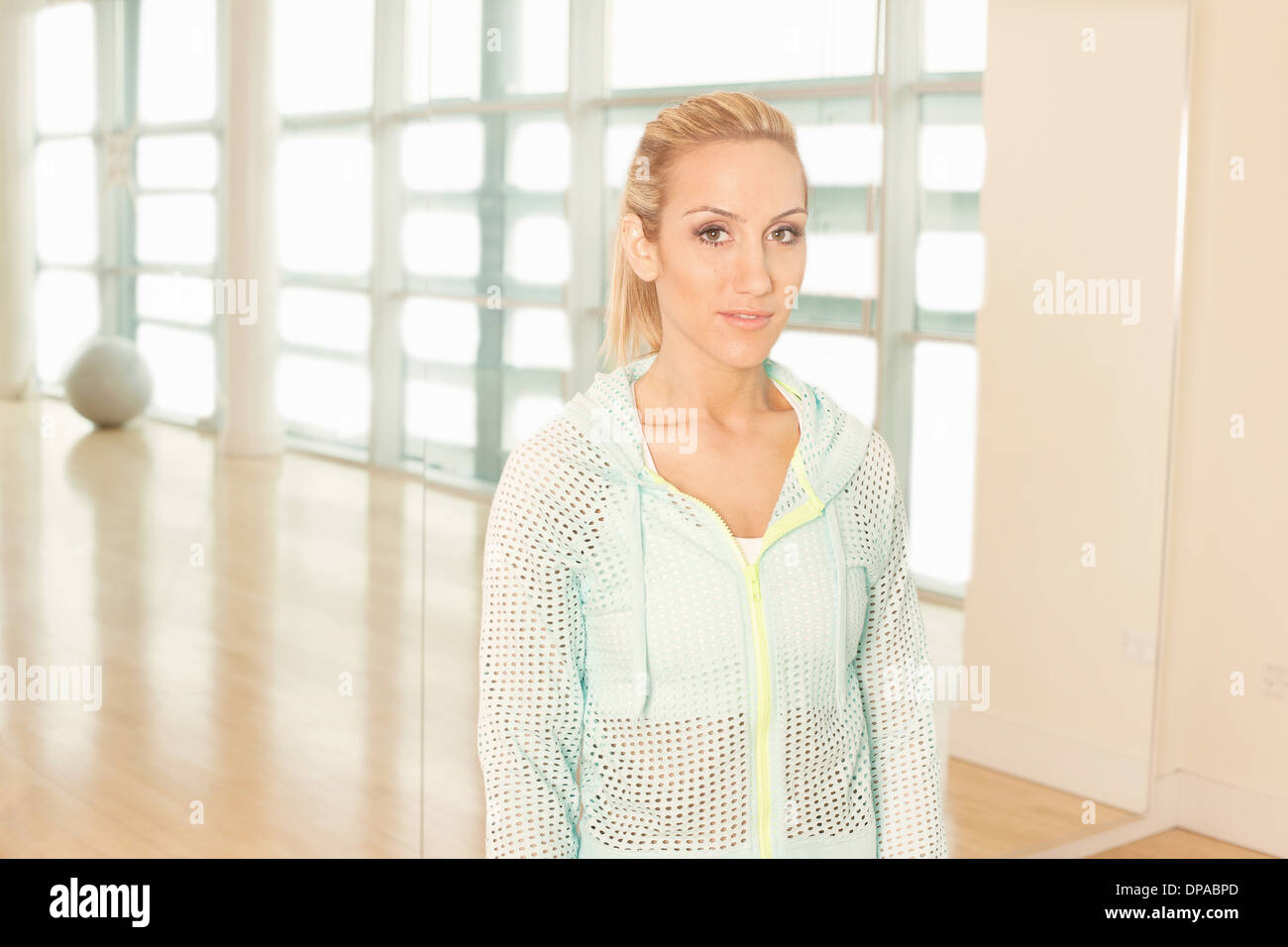 Woman standing in gymnasium Stock Photo