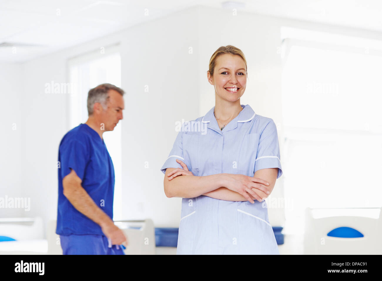 Portrait of nurse with doctor in background Stock Photo