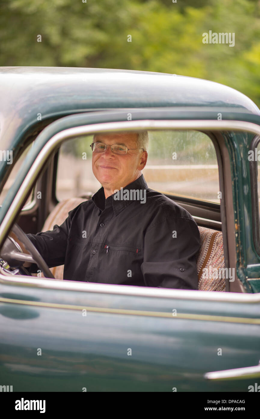 Older man in a classic car Stock Photo