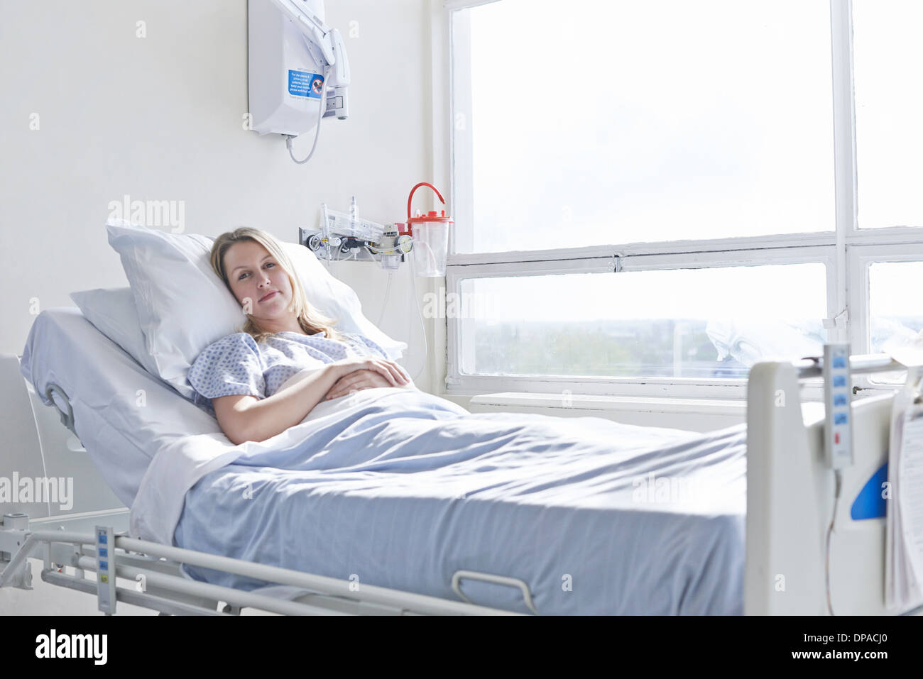 Patient lying in hospital bed Stock Photo