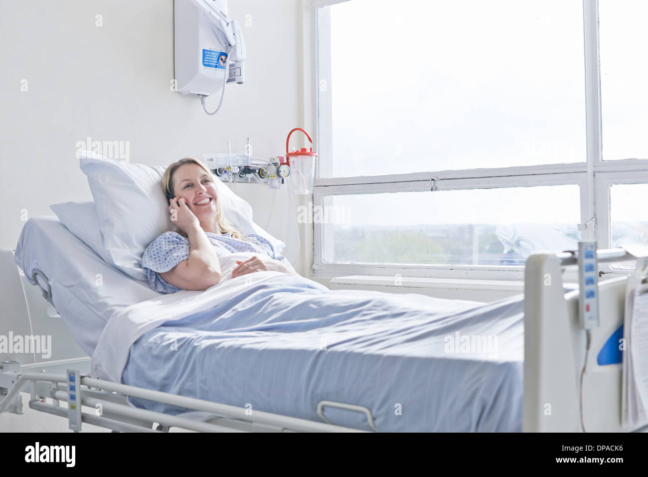 Patient lying on hospital bed on telephone call Stock Photo Alamy