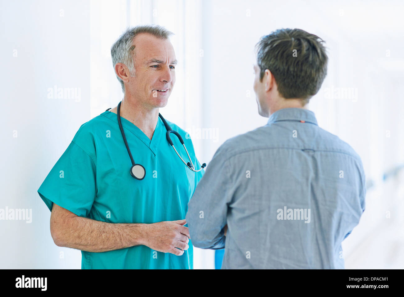 Surgeon talking to man Stock Photo