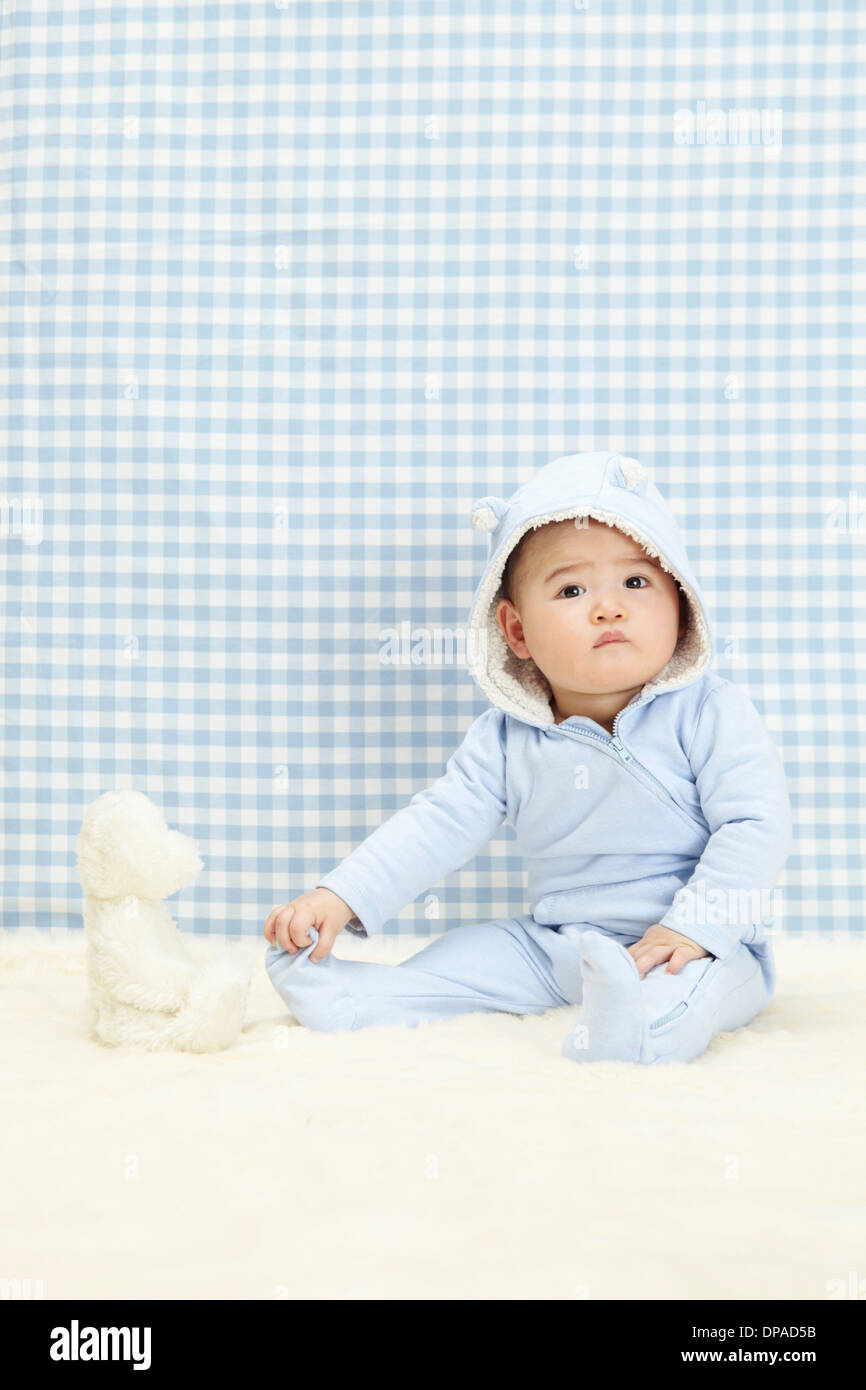 Baby boy sitting with soft toy Stock Photo - Alamy