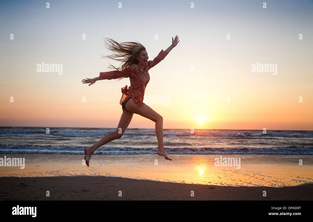 Woman jumping for joy Stock Photo