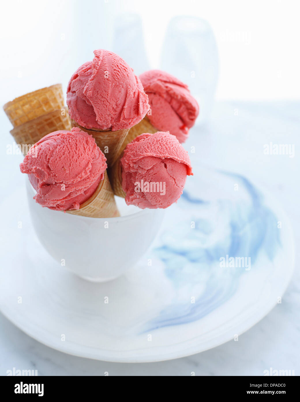 Bowl of ice cream cones filled with strawberry ice cream Stock Photo