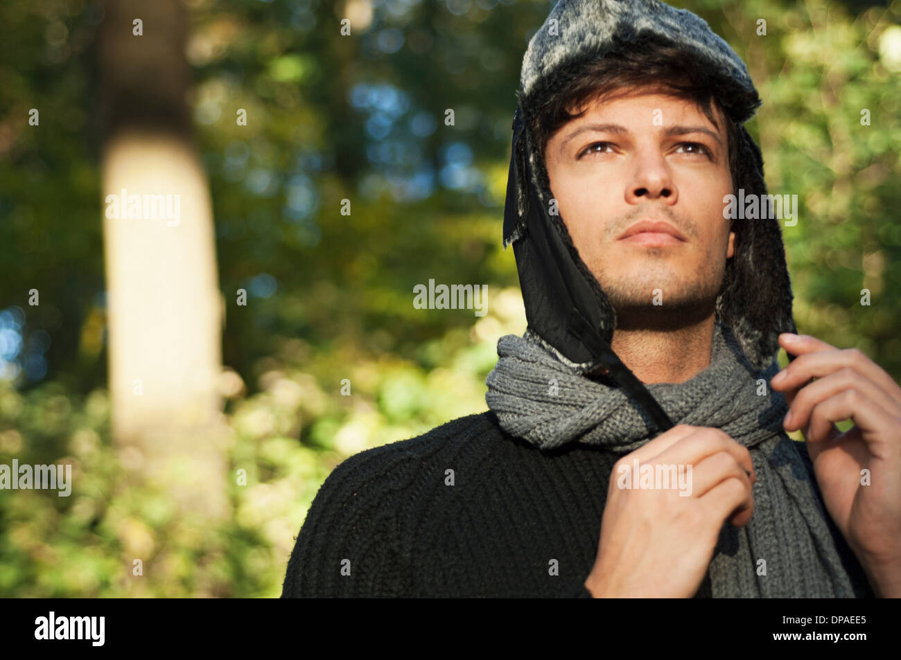 Portrait of man wearing hat and scarf, looking away Stock Photo