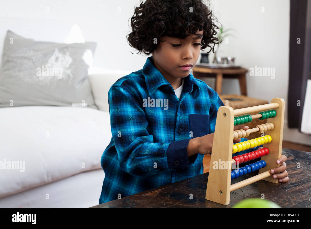 Boy playing with abacus Stock Photo