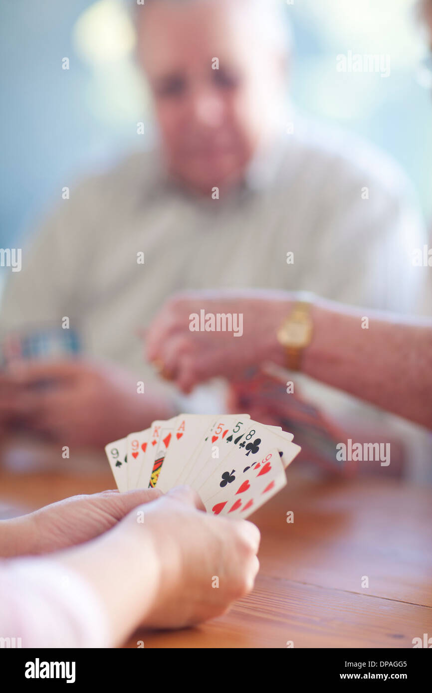 Senior male playing cards with family Stock Photo Alamy