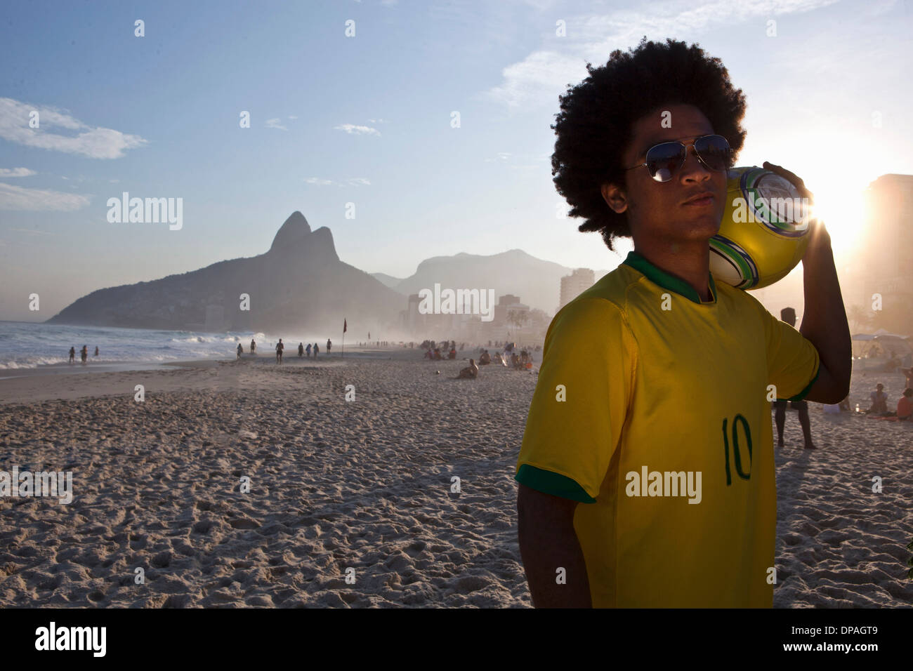 Young man at the beach with football, Ipanema Beach, Rio, Brazil Stock Photo