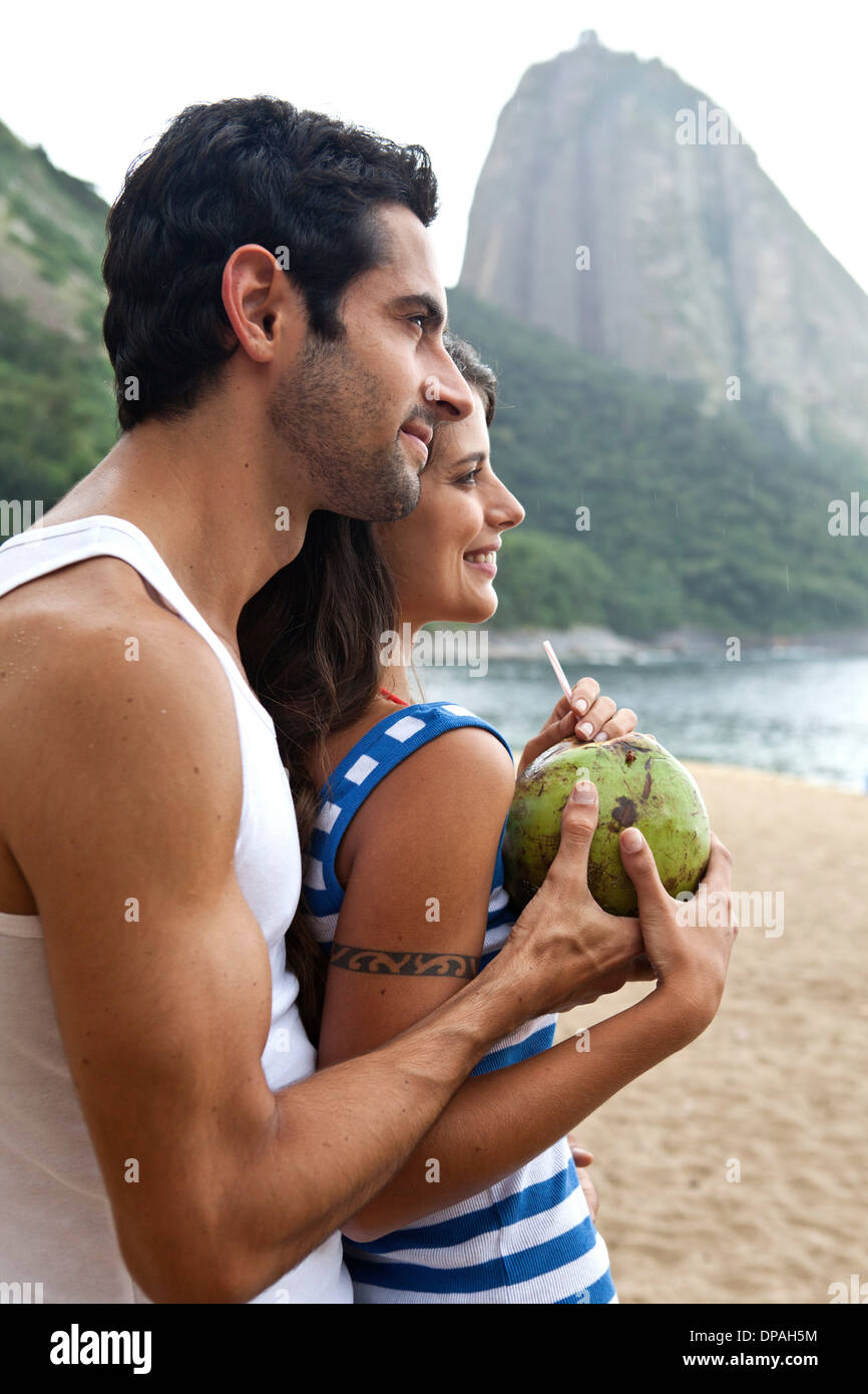 Portrait of couple on beach with Sugarloaf Mountain, Rio de Janeiro, Brazil Stock Photo