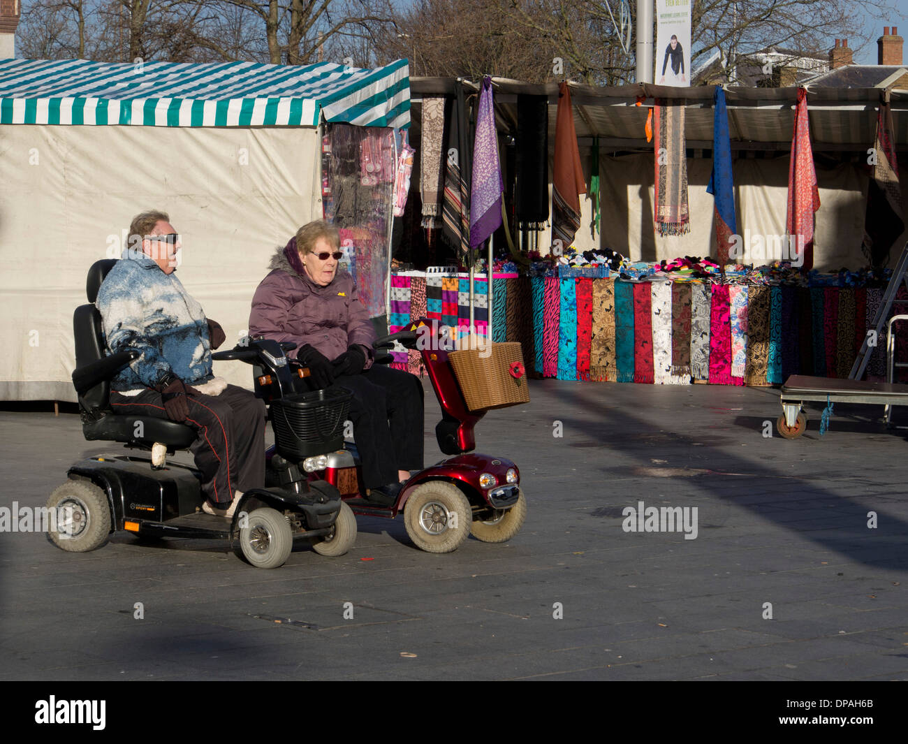 senior-women-in-electric-buggies-at-woolwich-market-london-uk-stock