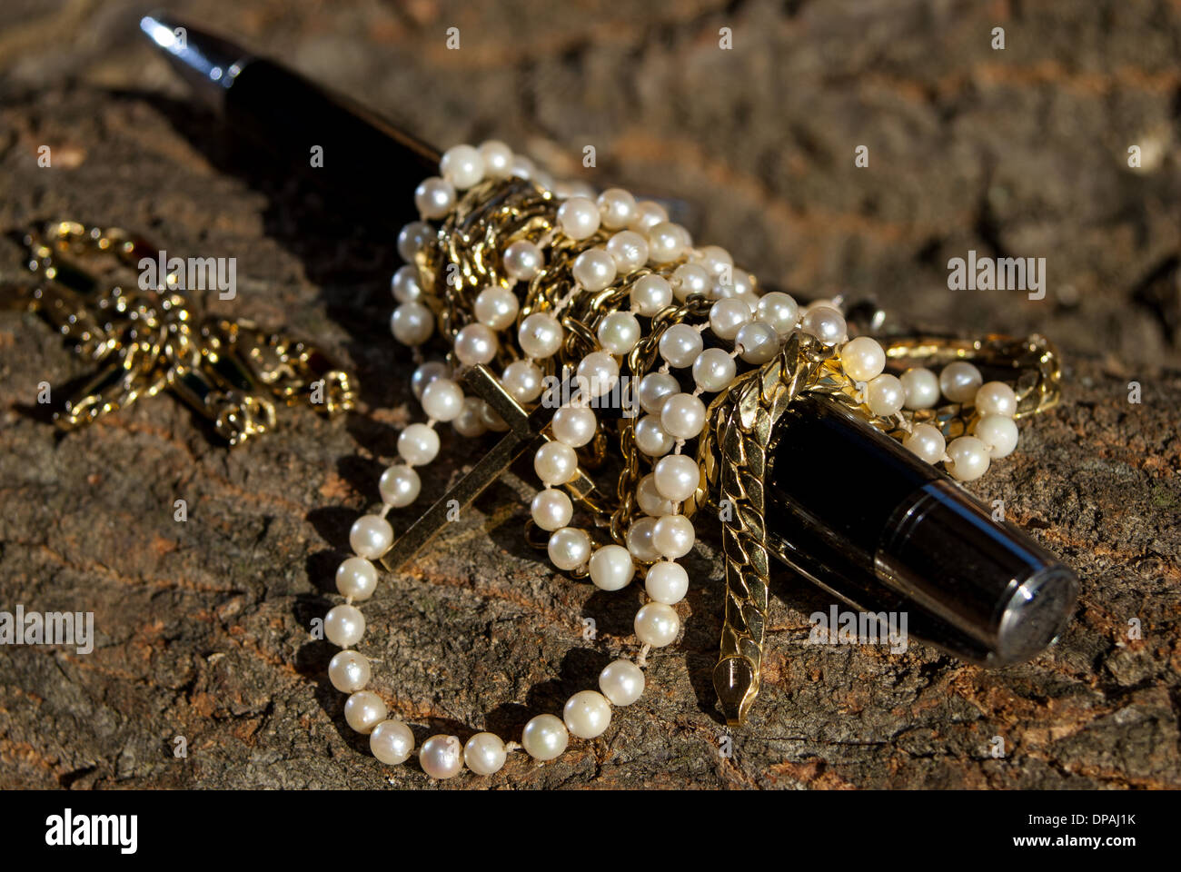 concept of beauty and elegance: jewerly and pen Stock Photo
