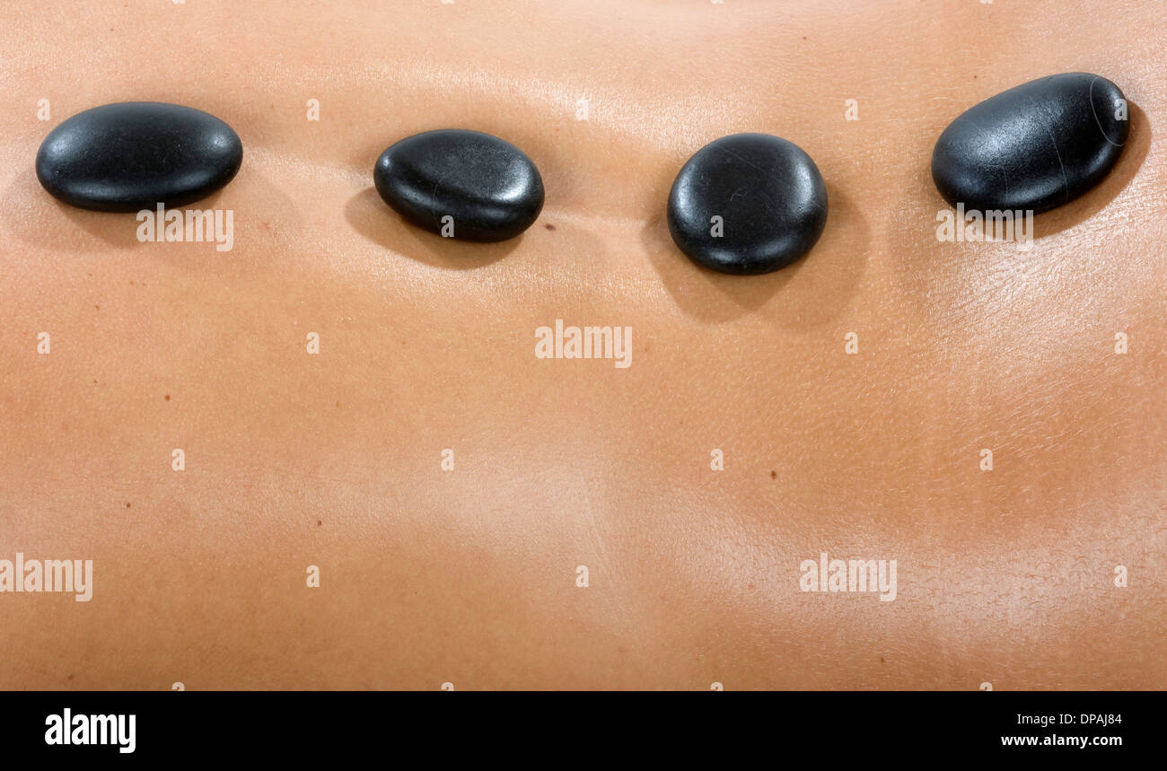 Hot stones on woman's back Stock Photo
