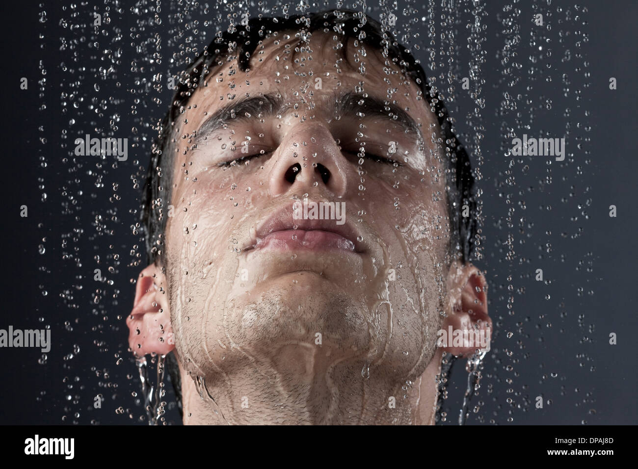 Young man covered with water droplets Stock Photo Alamy