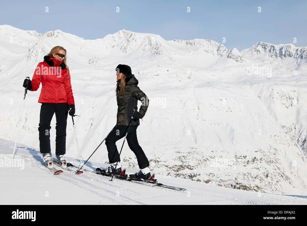 Two female skiers talking, Obergurgl, Austria Stock Photo