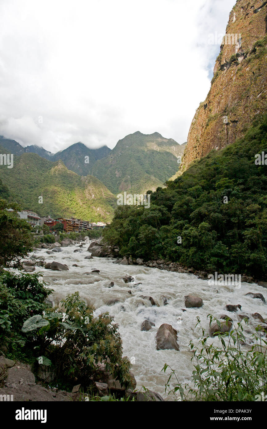 The Urubamba River rushes through Aguas Calientes, near Machu Picchu, Peru Stock Photo