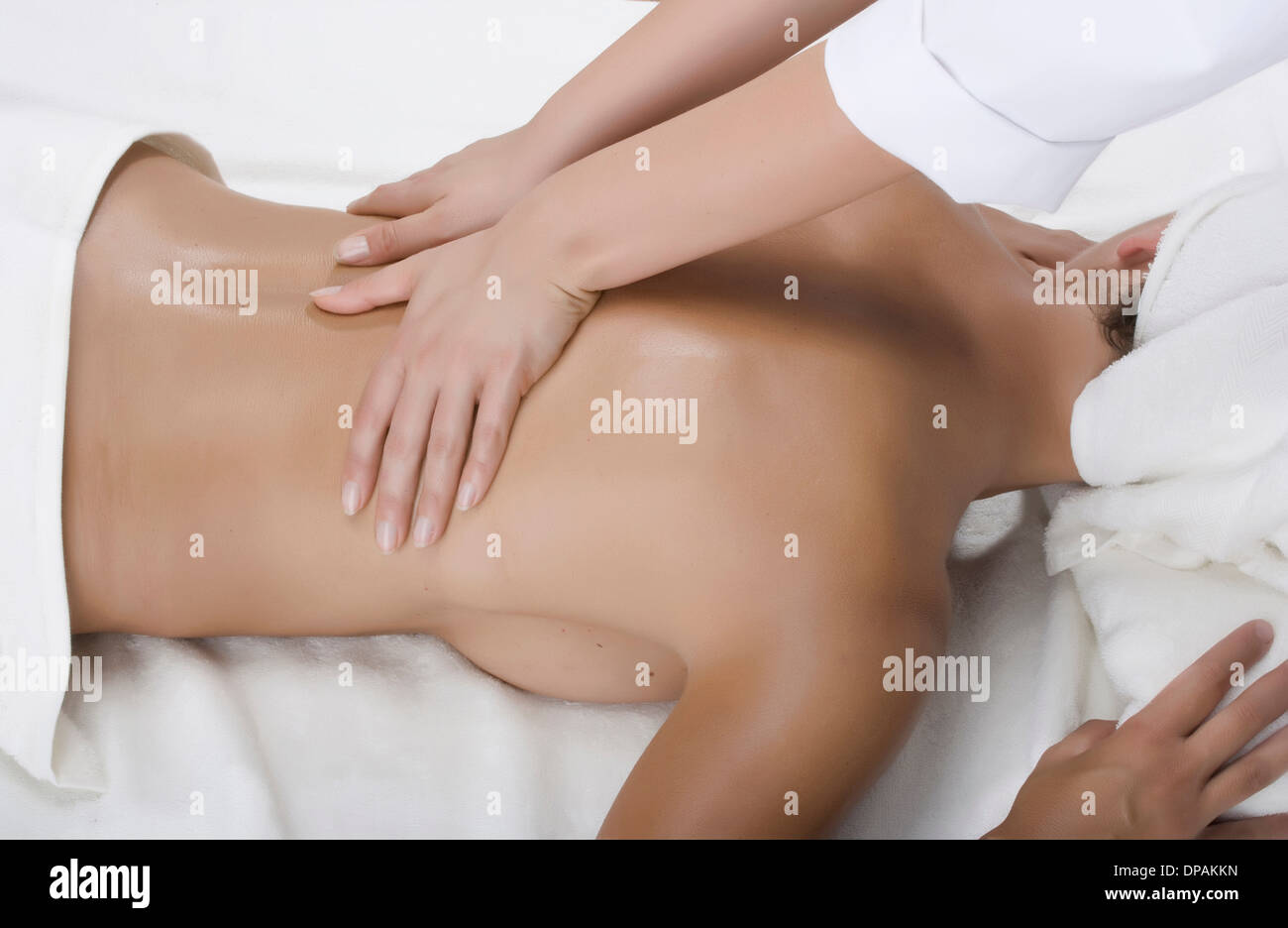 Person massaging woman's back Stock Photo