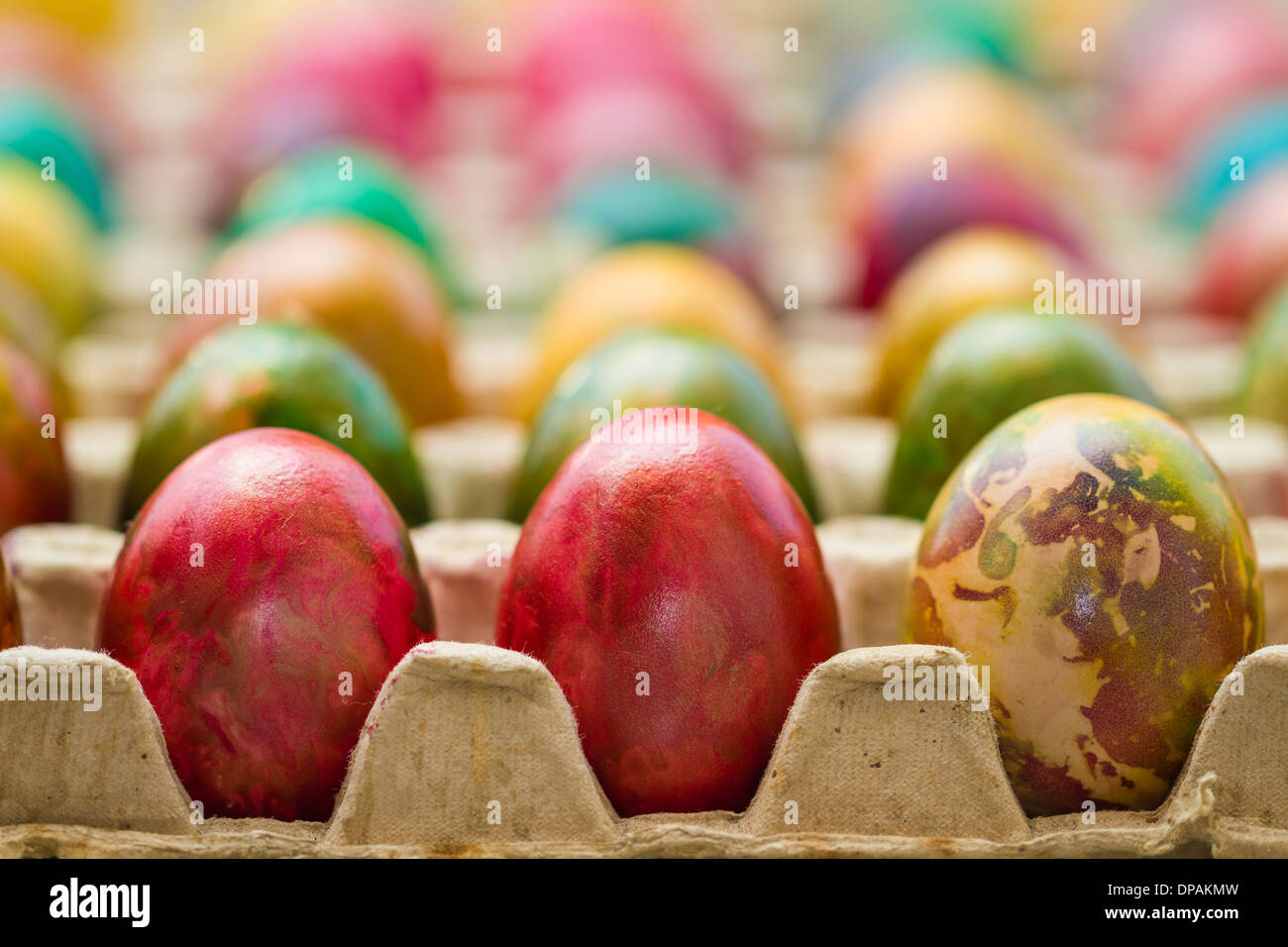 Easter eggs in various colors placed in row. Stock Photo