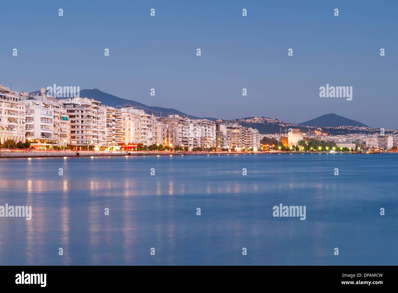 Dusk view of the waterfront and buildings on Nikis Avenue in Thessaloniki, Greece. Stock Photo