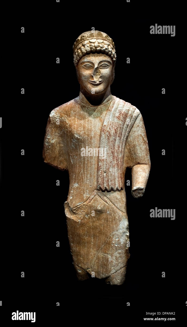 young man wearing a vegetable crown statue offered in a sanctuary Cyprus to 480-460 BC painted limestone Stock Photo
