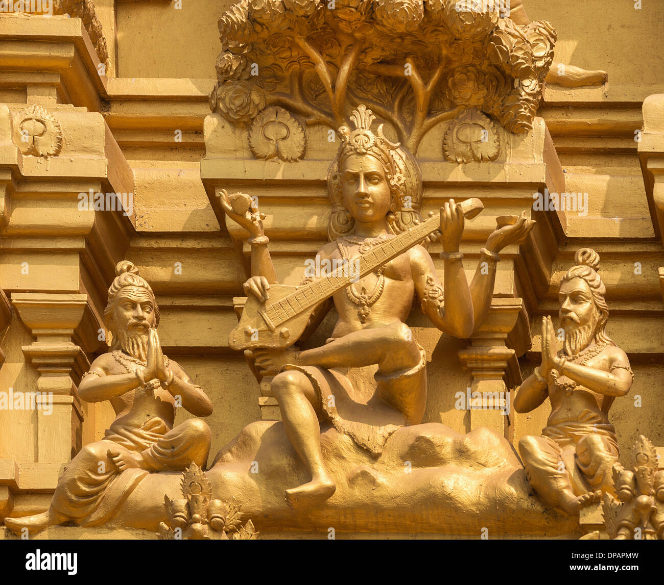 Detail of statues on the golden entrance tower at Sri Naheshwara in Bengaluru: Saraswati, goddess of knowledge and education. Stock Photo