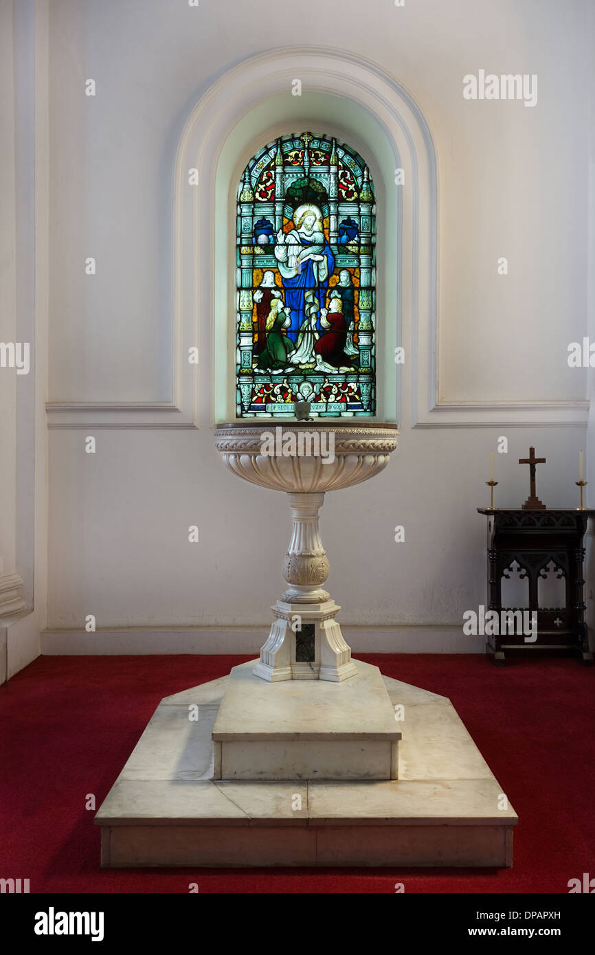 Baptismal font picture under stained glass window at Saint Mark's Cathedral in Bengaluru. Stock Photo