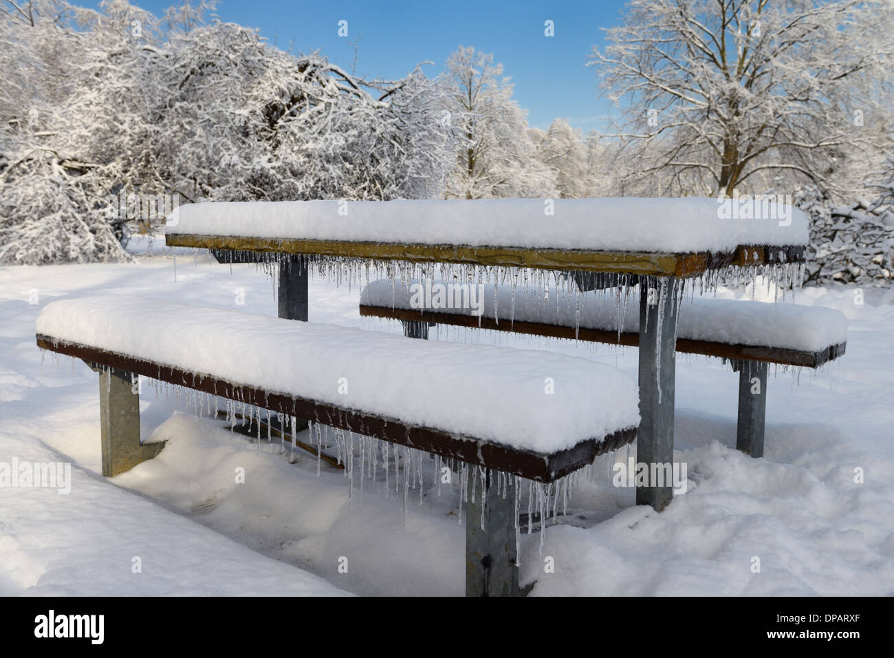 Icicles on a picnic bench in Rowntree Mill Park Toronto after a ice and snow storm Stock Photo