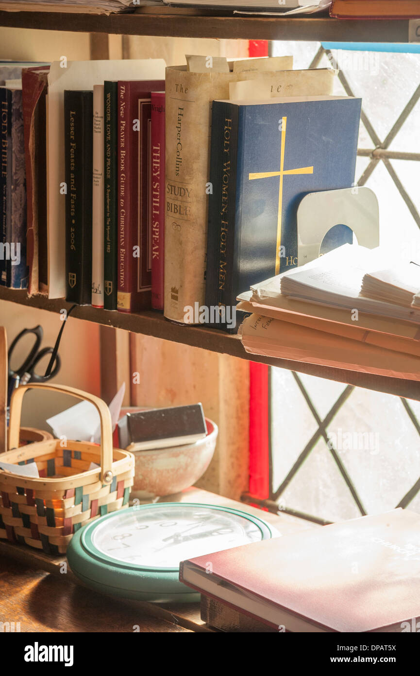 Bible on book shelf with window Stock Photo