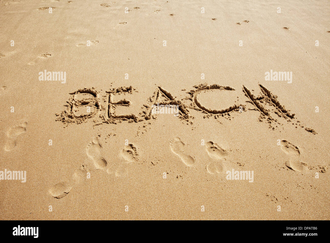 Message or greeting written in sand at the beach Stock Photo
