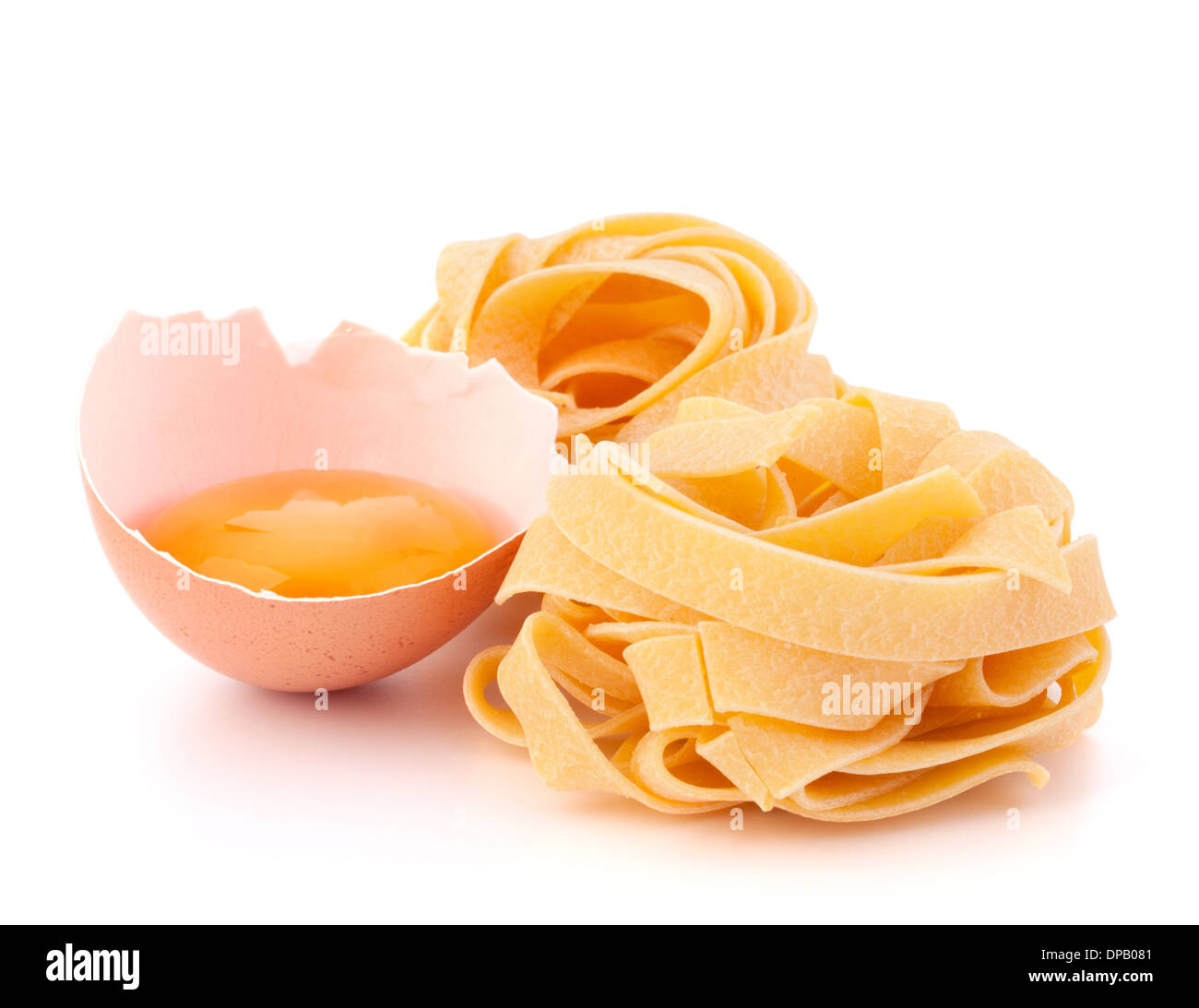 Italian egg pasta fettuccine nest isolated on white background Stock