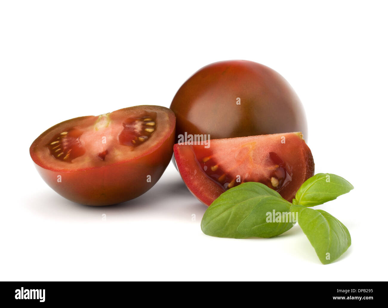 Tomato kumato and basil leaf isolated on white background Stock Photo