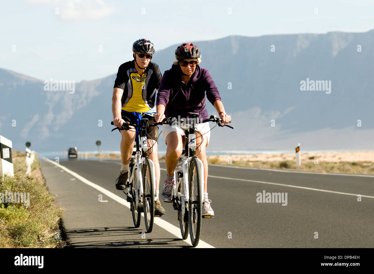 cycling in lanzarote canary islands island canaries holiday holidays cyclist cyclists bike ride riding riders Stock Photo