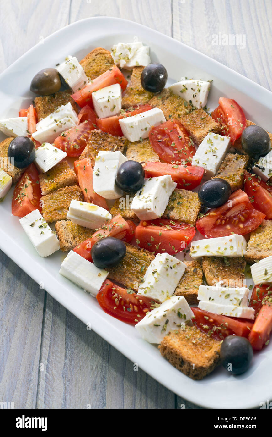 Mediterranean salad with cheese, tomatoes, olives, bread, dill ... Stock Photo