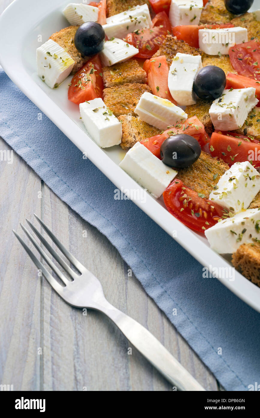 Mediterranean salad with cheese, tomatoes, olives, bread, dill ... Stock Photo